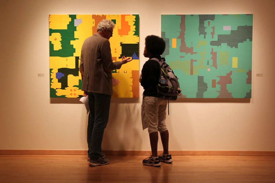Paul Ryan, left, talks with Anthonia Adams about his work hanging in the Staniar Gallery. Photo by Ellen Kanzinger, 18