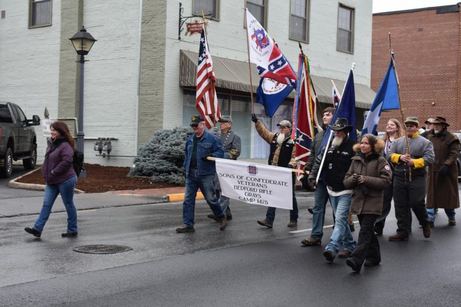 Participants march with flags during the Lee-Jackson Day parade. Photo by Hannah Denham.