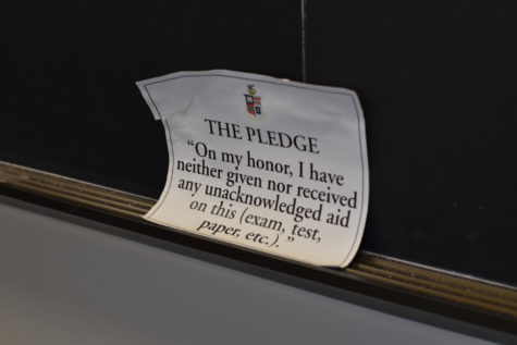 White paper sign that reads The Pledge: On my honor, I have neither given nor received any unacknowledged aid on this test, paper, etc... leaned against a chalkboard