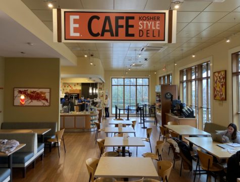 A wide view of a cafe with seating and tables. A sign says E cafe
