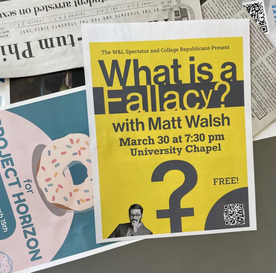 A+photo+shows+multiple+signs+and+papers.+The+focus+is+a+yellow+and+black+sign+reading+What+is+a+Fallacy%3F+with+Matt+Walsh.