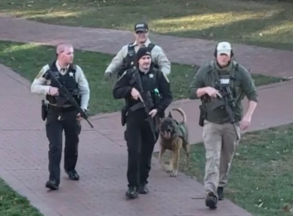 A group of law enforcement officers, including a K-9 unit, patrol Washington and Lee’s campus during an hours-long police search. Photo obtained by the Phi