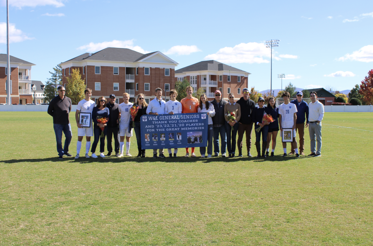 Head coach Mike Singleton (far right), assistant coaches and senior players get together on W&L men’s soccer’s senior day.