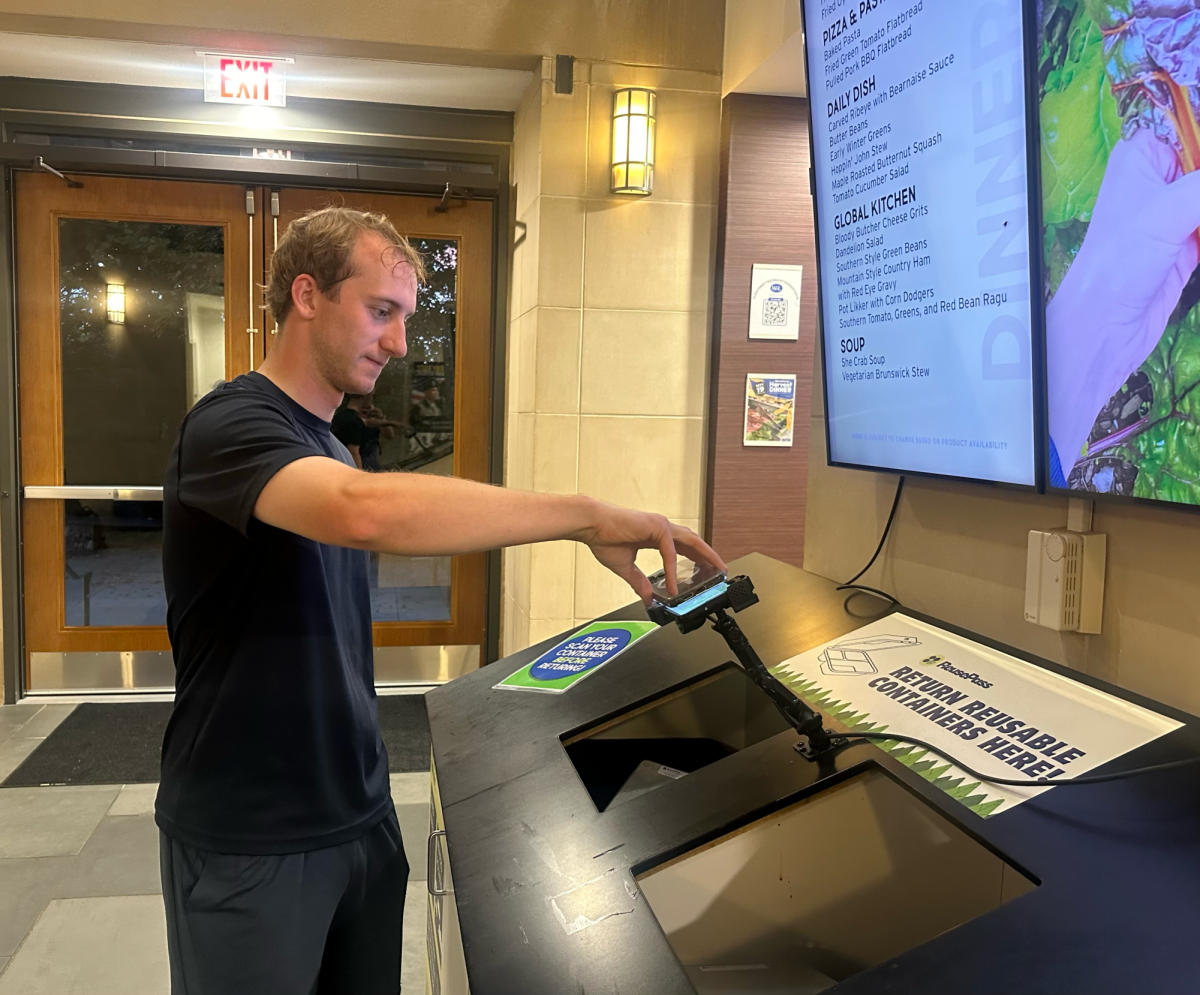 A student scans their ReusePass code to return a to-go box. 