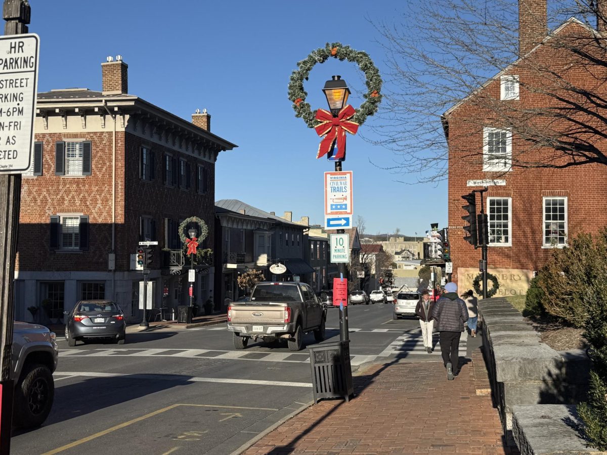 Christmas wreaths decorate downtown Lexington at the corner of Main Street and Washington Street. Local business owners say students should make more of an effort to shop downtown during the holiday season. 