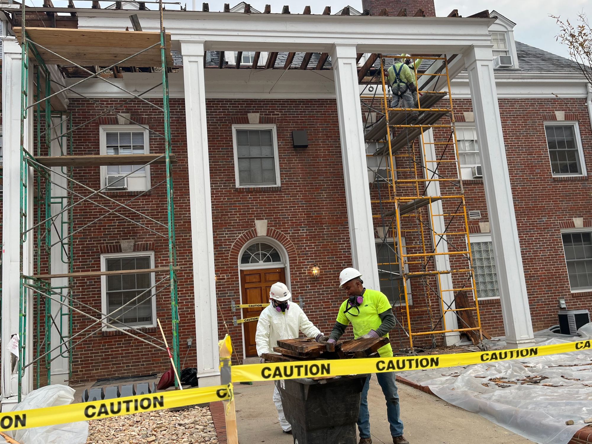 Demolition workers take down Pi Kappa Alpha’s porch in November of 2023. 