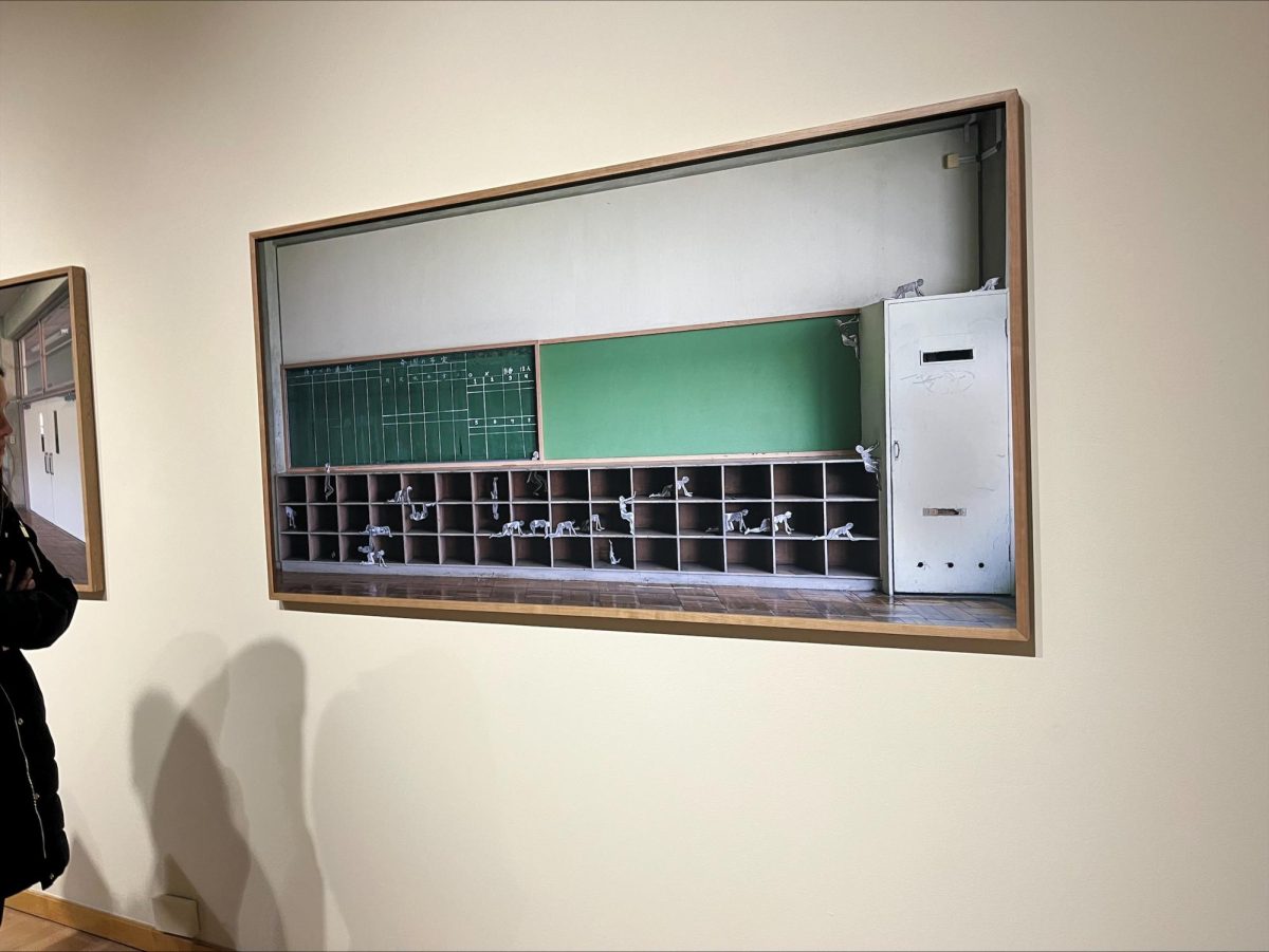 Joey Fauerso used paper dolls and school cubbies to create a piece that explores space and structures within schools. 